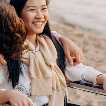 Girl smiling in wheelchair on the beach